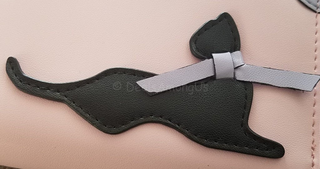 CloseUp of Cat on Pink Wallet